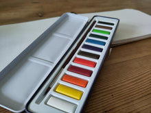 Watercolour paints and pad.